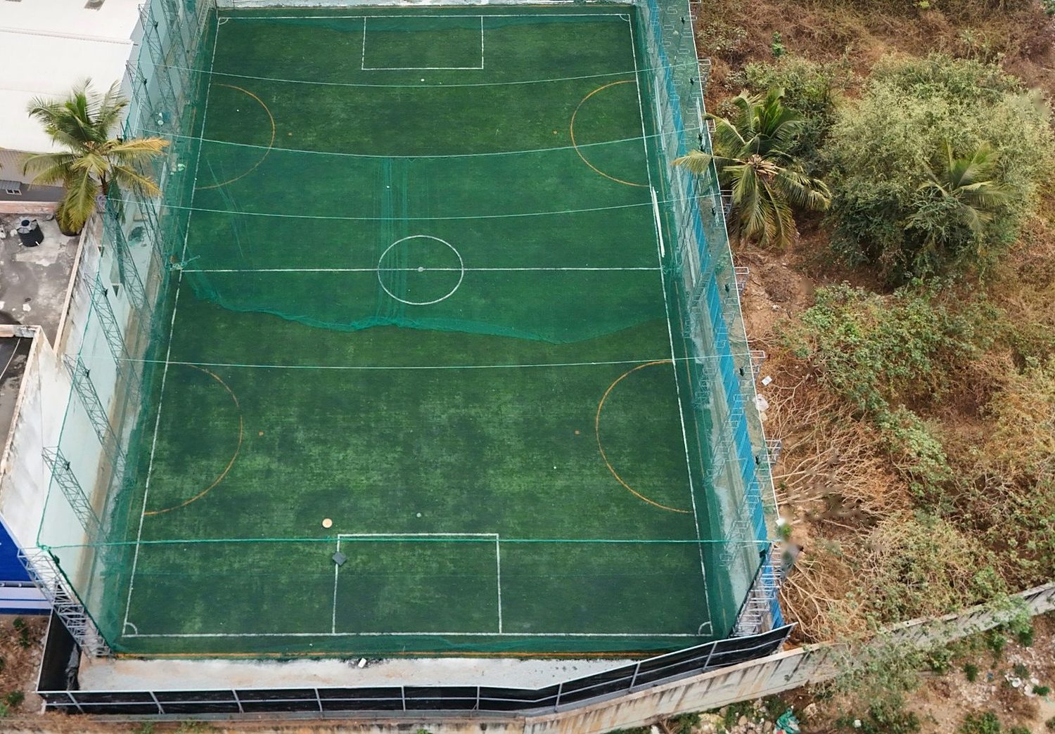 Drone view of The Big Box Turf with its floodlight towers and netting