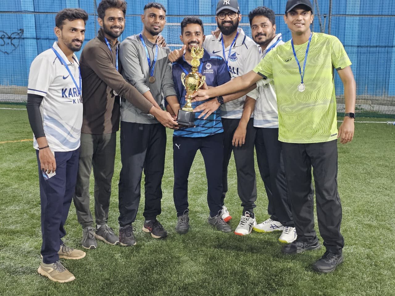 Karavali Kings players holding their trophy together