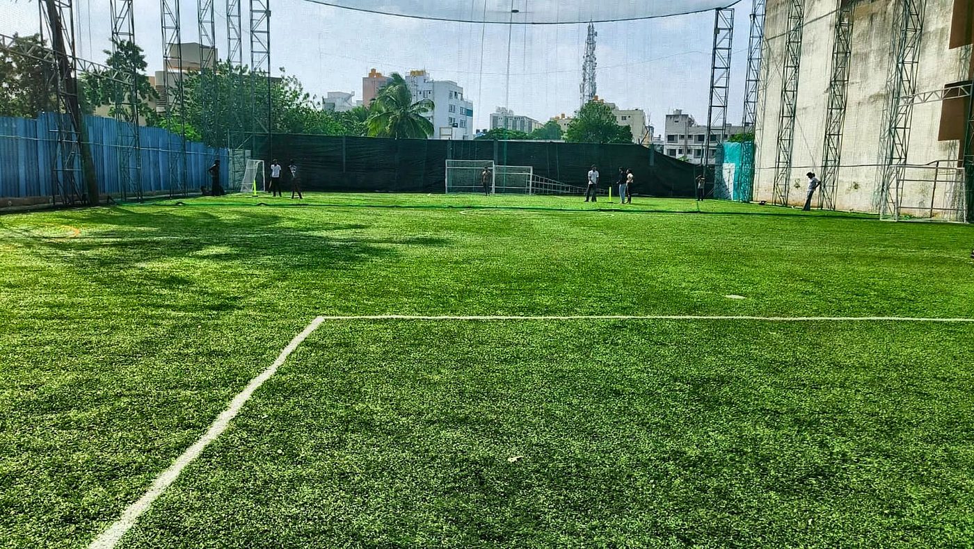 Box cricket match on the full turf in daylight