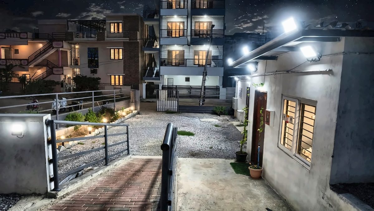 Well-lit entrance path and parking at night