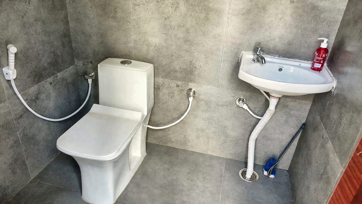 Clean toilet with a wash basin and hand wash
